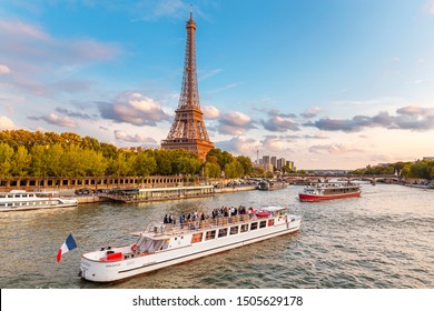 27 July 2019, Paris, France: The Main Attraction Of Paris And All Of Europe Is The Eiffel Tower In The Rays Of The Setting Sun On The Bank Of Seine River With Cruise Tourist Ships