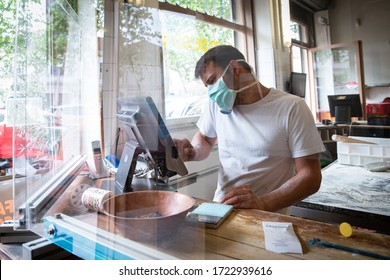 27/04/2020, Lyon, Rhoen Alpes Auvergne, France : Man Is Working In A Pizza Restaurant Drive With His Mask And Covid 19 Protection. Pandemic Situation