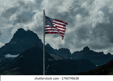 2709 Old Glory, the American Flag, stands out against a stormy sky over Swiftcurrent Lake at Glacier National Park - Montana