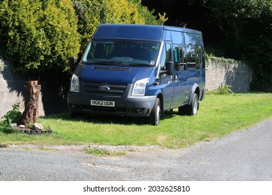 27th August 2021- A Ford Transit 135 T430 RWD High Roof Minibus Parked On A Grass Verge By A Road Near Laugharne, Carmarthenshire, Wales, UK.