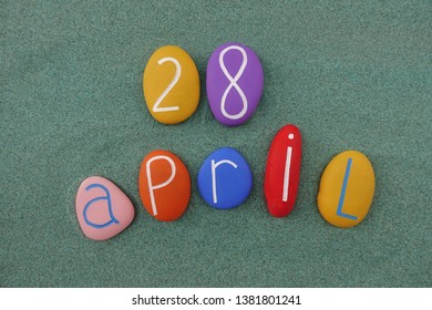 28 April, calendar date with colored stones over green sand