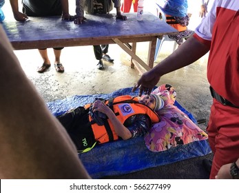 28 Jan 2017 - Jerantut , Pahang, Malaysia :  Medic team / Bulan Sabit Merah Malaysia rescue a convict in kampung kelola, patients suffering from paralysis in flood when Pahang river overflowed