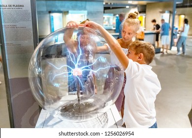 28 JULY 2018, BARCELONA, SPAIN: People Playing With Plasma Ball In Science Museum