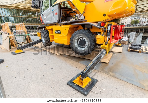28 July 2019, Paris, France: Excavator hydraulic\
crane support on asphalt