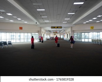 28 Jun 20, Donmueng Airport, Bangkok, Thailand. Group Of Cabin Crew In Red Uniform Waking With Trolley Bag In Empty Terminal. Airport Terminal With No Or Few Passenger During Covid19.