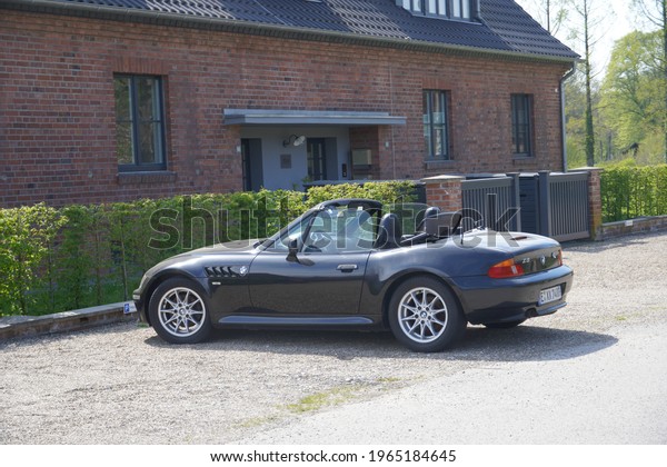 Düsseldorf,Germany-Aril 28,2021: Black BMW Z3 parks\
in front of a House, is a range of two-seater sports cars which was\
produced from 1995 to\
2002.