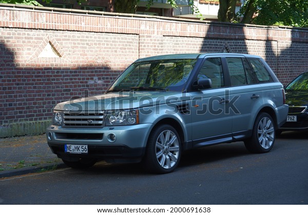 Mönchengladbach,Germany-June\
28,2021: Land Rover Range Rover Sport TDV6 wagon first generation\
parked in Mönchengladbach,is a British mid-size luxury SUV made by\
Land Rover from\
2005-2013