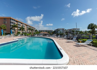 2829 Florida Blvd Delray Beach FL, Miami, USA,
June 13, 2020
Fenced Pool, With Sun Loungers, Umbrellas, Chairs And Tables, Buildings And Boats In The Background With Tropical Plants And Blue Sky 