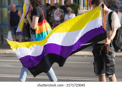 28th June LGBT Pride Day. Young person holding the Non Binary flag at the pride parade and demonstration for the LGBTIQ+ rights.  - Shutterstock ID 2171723045