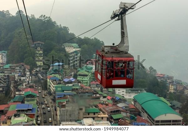28th March, 2021, Gangtok, Sikkim,\
India: Tourists enjoying a rope way cable car or Gondola ride over\
Gangtok city during sunset. Amazing aerial view of\
Sikkim.
