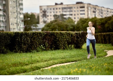 29 Year Old Woman Is Jogging In City Park.