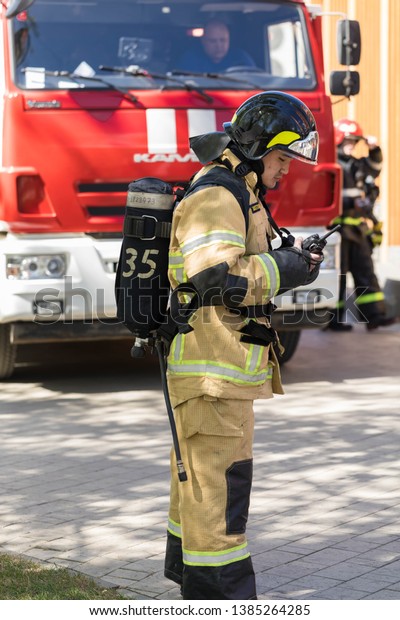 29.04.2019 Russia, Moscow. Fire-fighting crew on\
departure on fire extinguishing. the fireman is cost at the fire\
truck with the radio\
set