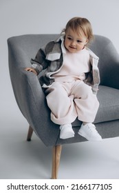 29.04.22 Kyiv, Ukraine: little stylish girl of one and a half years poses for a photo on a white studio cyclorama