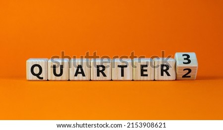 From 2nd to 3rd quarter symbol. Turned a wooden cube and changed words 'quarter 2' to 'quarter 3'. Beautiful orange table, orange background. Business, happy 3rd quarter concept, copy space.