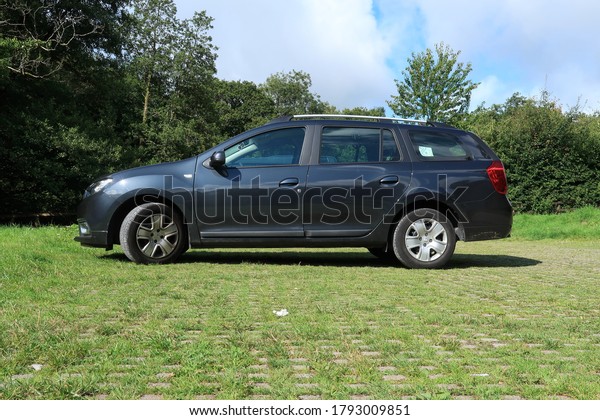 2nd August 2020-\
A grey Dacia Logan MCV Comfort Tce, five door estate car, in the\
public parking area at Green Castle Woods near Carmarthen,\
Carmarthenshire, Wales, UK.