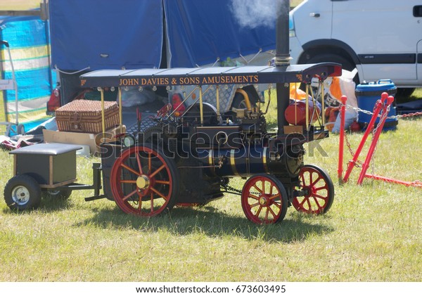 2nd July 2017- A scaled down\
model on a steam powered traction engine at a classic car show in\
Pambrey Country Park near Llanelli, Carmarthenshire, Wales,\
UK.