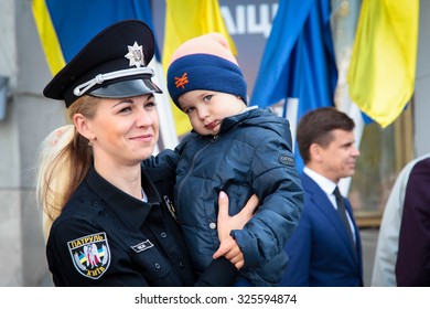 2-Oct-2015 Zhytomyr, Ukraine
A patrol police woman holding a child in her arms at the ceremony of the start of the recruiting for the new patrol police in Zhytomyr, Ukraine