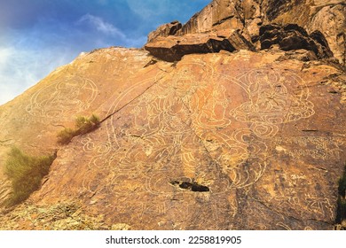 3 ancient images of Buddha on a rock in the Tamgaly tas tract on the Ili River in the Almaty region of Kazakhstan. - Shutterstock ID 2258819905