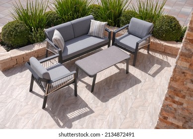 3 Black And Beige Sofas And A Table Made Of Metal In The Courtyard And Garden On The Garden Floor, Comfortable Sofa, Shot From Above