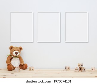 3 Blank Vertical Frames Mockup On Wall For Nursery Wall Art Display, Baby Room Three White Frames Mock Up, Wooden Shelf, Soft Toys And Wooden Toys On Shelf.