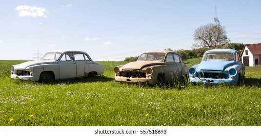 3 broken oldtimer on meadow