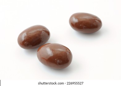 3 Chocolate Covered Almonds On White Background