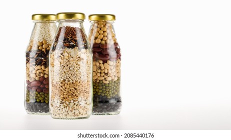 3 Clear Glass Bottles Contain Clean Organic Cereal Grains, Seeds, Dry Crops, Beans, Rice As Raw Ingredients And Material Recipe Of Healthy Vegan Food Cooking And Drink Menu From Natural Mixed Compound