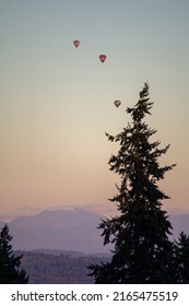 3 Colorful Hot Air Balloons Fly At Sunset In Snohomish County Washington During The Summer