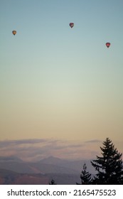 3 Colorful Hot Air Balloons Fly At Sunset In Snohomish County Washington During The Summer