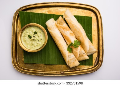 3 Dosa Rolls With Coconut Chutney In A Brass Tray Over Coconut Leaf, Favourite South Indian Meal,top View, Isolated On White Background