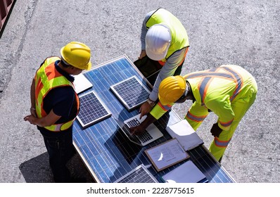3 engineer working in clean solar energy industry talking about the design engineer of solar panel