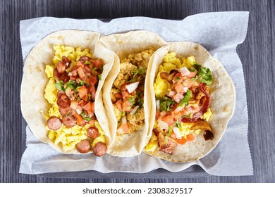 3 flour tortilla Mexican breakfast tacos sausage chorizo bacon with toppings background asset