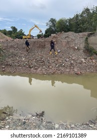 3 June 2022 - Tumpat, Malaysia : A Surveyor And His Assistant Are Checking The Coordinates Or Location Of A Structure To Be Built Using GNSS Tools At A Construction Site.