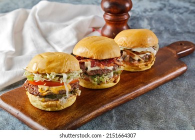 3 Kind Of Burger Classic Mushroom, Bacon, Cheese Burger With Lettuce, Tomato And Melted Cheese On Wooden Board
