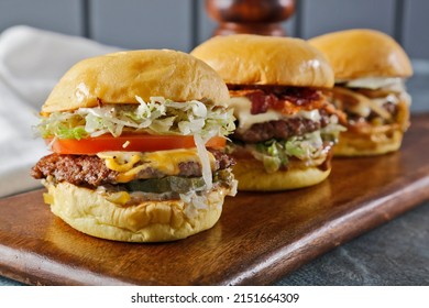 3 Kind Of Burger Classic Mushroom, Bacon, Cheese Burger With Lettuce, Tomato And Melted Cheese On Wooden Board
