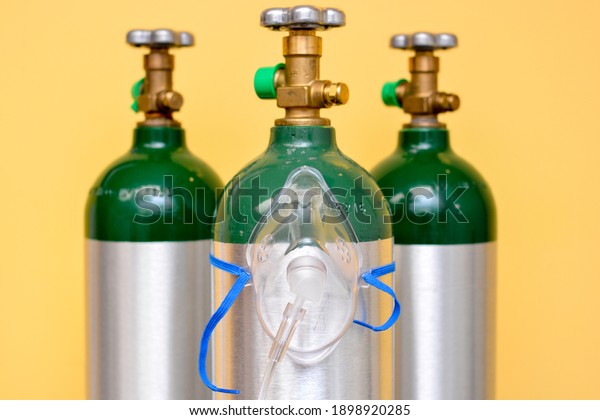 3\
Medical Oxygen Tanks with Oxygen Mask on One of\
Them