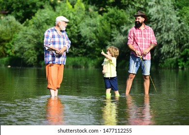 3 Men Fishing On River In Summer Time. Grandfather And Grandchild. Man In Different Ages. Dad And Son Fishing At Lake