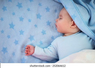 3 month old baby sleeping on blue blanket