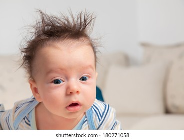 3 Months Old Baby Boy Portrait With Messy Hair And Sleepy.