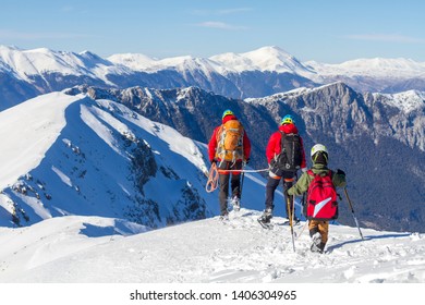 3 Mountain Climbers Walk On Snow In The Mountains