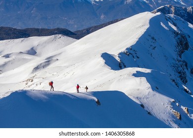 3 Mountain Climbers Walk On Snow In The Mountains