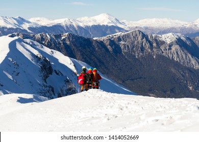 3 Mountain Climbers Walk On Snow In The Mountains