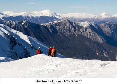 3 Mountain Climbers Walk On Snow In The Mountains