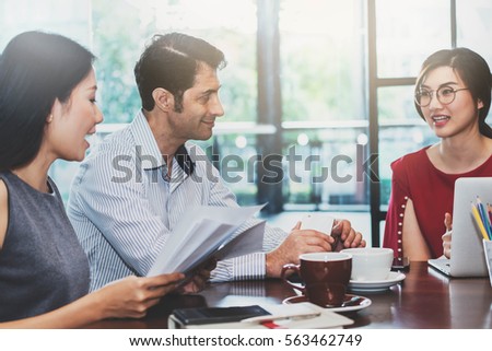 3 people meeting in coffee shop, business casual conceptual