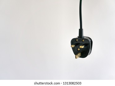 3 Pin 13 amp plug hanging with white background