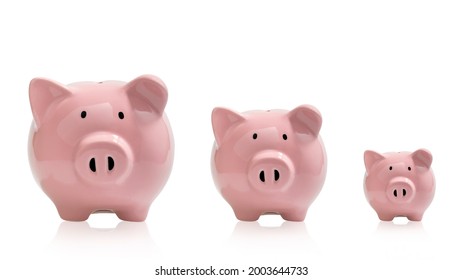 3 pink pig piggy banks on white background. Saving money. With clipping path. - Shutterstock ID 2003644733