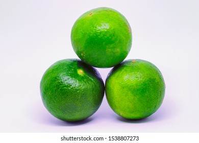 3 Round Kiefer / Key Limes Stacked In A Pyramid Isolated On A White Background.