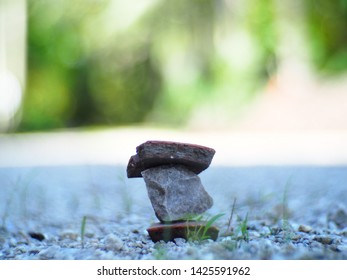 3 Stacked Stones In The Forest