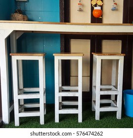 3 stools and side table  in coffee shop 