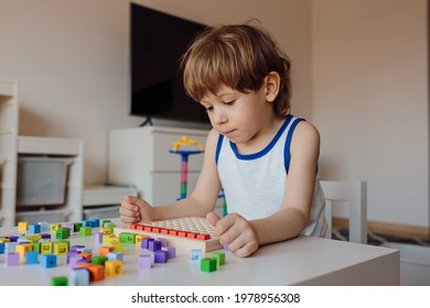 3 Year Old Boy Is Immersed In His Own World. Child Obsession With Numbers And Counting. Manifestation Of Autism In Children